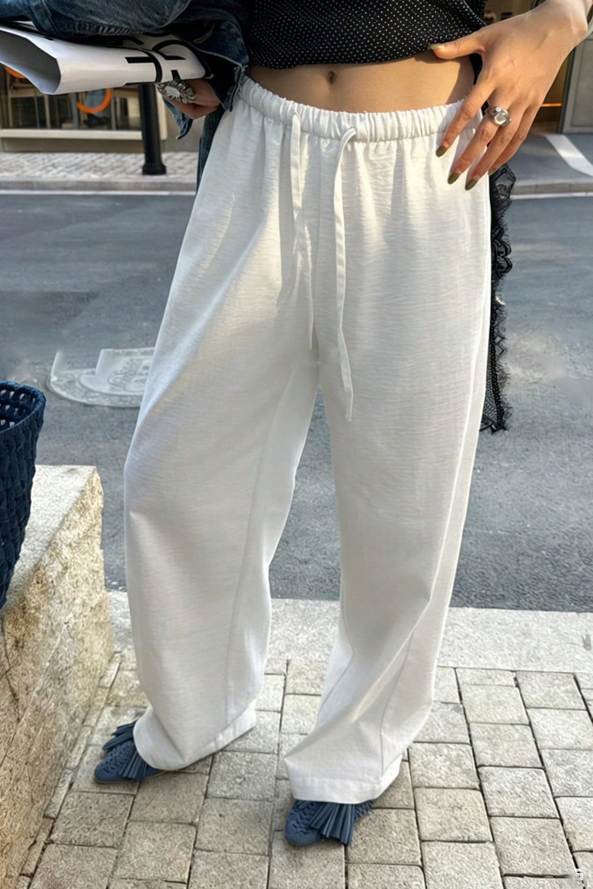Luźne damskie spodnie wide leg z kieszeniami, ujęcie z boku